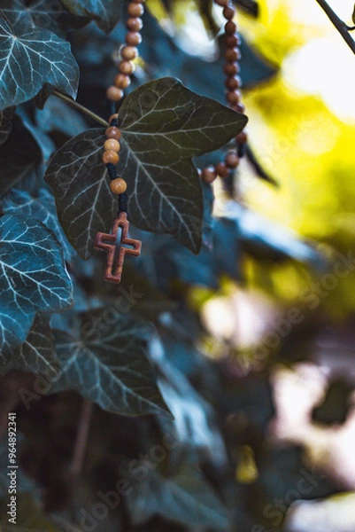 Fototapeta Wooden rosary with cross - with bokeh in background