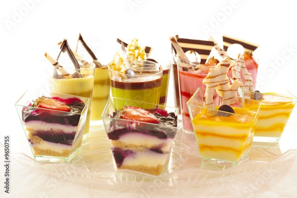 Fototapeta An assortment of colorful mousse desserts in cups.