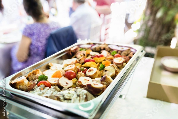 Fototapeta Colorful buffet featuring roasted meats, grilled vegetables, and fresh salads at a backyard gathering during late afternoon
