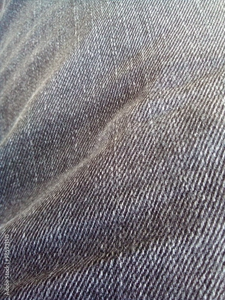 Fototapeta Gray denim fabric surface background. The photo was taken on a mobile phone.