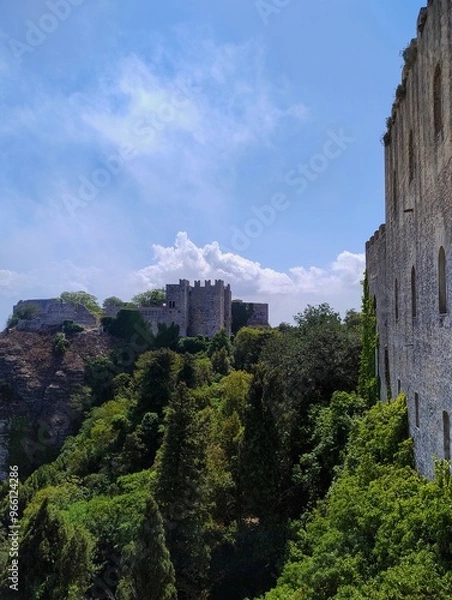 Fototapeta Ancient fortress. Historical norman castle on a hill surrounded by nature. Cloudy sky. Beautiful summer day in Erice with cablecar. Sicilian village. Italian life. 