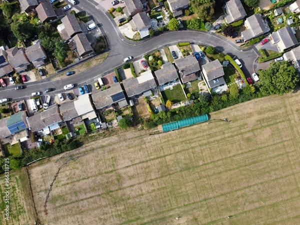 Obraz Aerial drone picture looking directly down on an area of low density housing on the edge of the cricket pitch