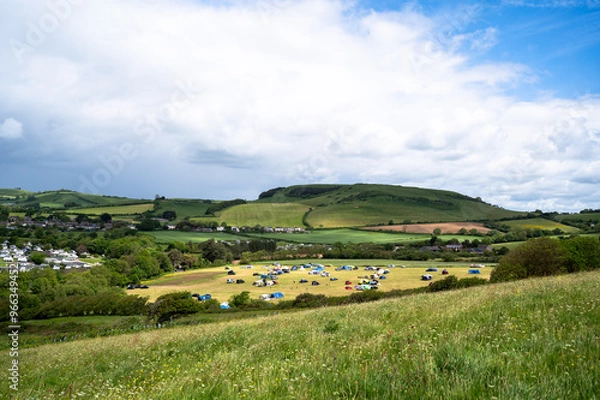 Fototapeta Campsite in the rolling countryside landscape at Bridport in Dorset, England