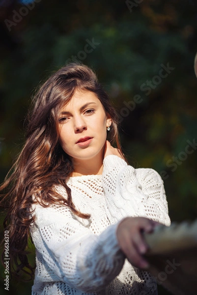 Fototapeta Two happy and cheerful young girl students, blond and brunette in coat and jeans laughing in sunny autumn park full of fallen leaves, horizontal pictures