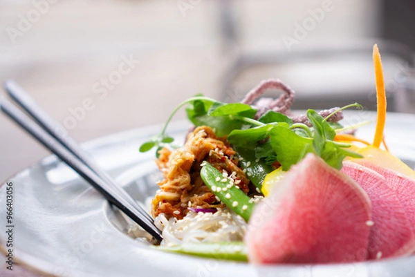 Obraz Healthy vegan dish with noodles, beans, greens, sliced red onion, and textured protein.