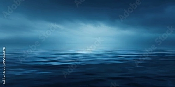 Fototapeta Calm and serene deep waters with rich blue shades under a tranquil sky at dusk