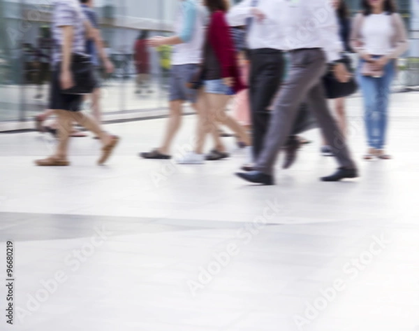 Fototapeta Abstract blurred people are walking in the city