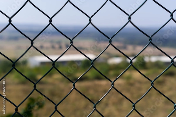 Fototapeta Close-up view of fencing that is made of steel wire. A device that prevents the entry of strangers and animals.