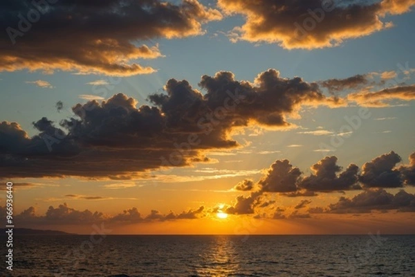 Fototapeta sunset, sky clouds over sea in the evening with orange, yellow gold sunlight in golden hour and dramatic fluffy, horizon sea summer sky landscape, dusk sky background