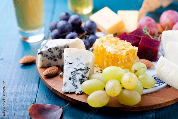 Obraz Cheese plate with fresh grape, honey, nuts,plum jelly, marmalade