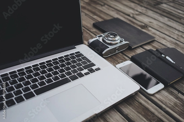 Fototapeta Mock up of modern laptop and smart phone template with vintage camera