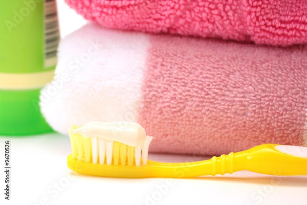 Fototapeta Yellow toothbrush with a toothpaste. Object over white