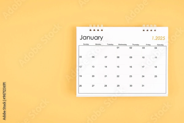 Fototapeta January 2025 desk calendar on yellow color background, position with copy space.
