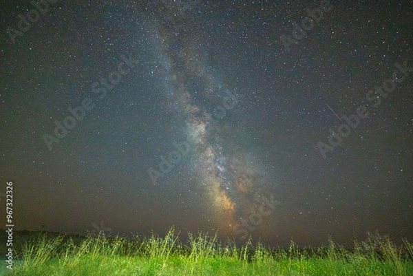 Obraz Night sky with the milky way core over green grass in country scenery. Brittany, France. Background with copy space.