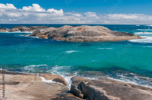 Fototapeta Western Australia, Green's Pool in Denmark, rocky coastline with clear water and distant waves under a partly cloudy sky.