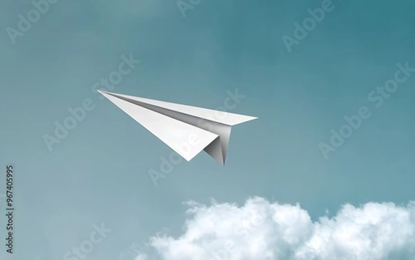 Fototapeta A photo of a paper airplane in mid-flight against a clear blue sky.