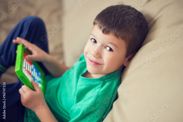 Obraz Little caucasian boy counting on abacus