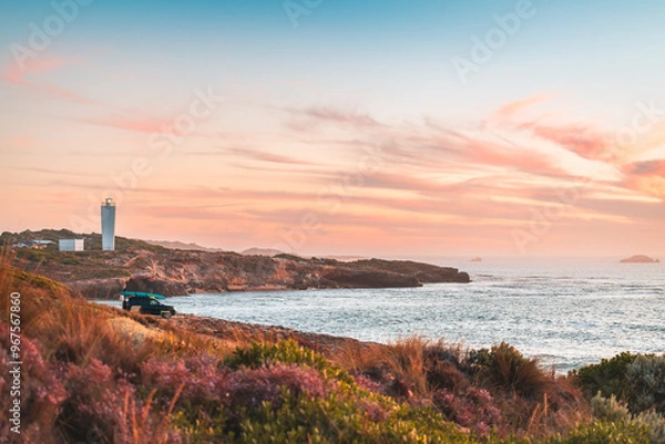 Obraz 4WD car parked on rocky beach in Robe with driver enjoying the scenic sunset view with ocean, South Australia