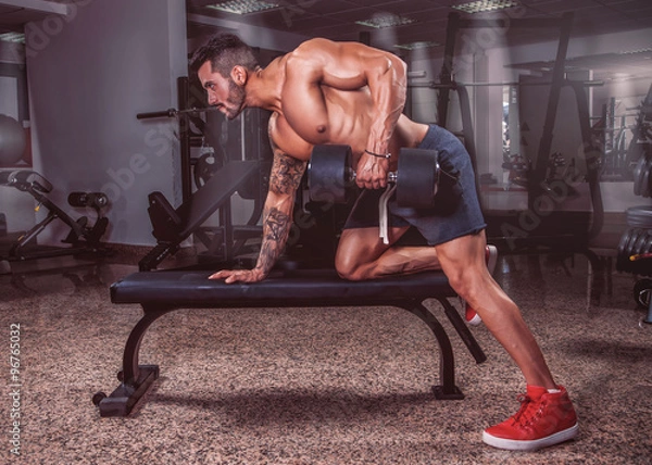 Obraz Handsome muscular man exercise in the gym.