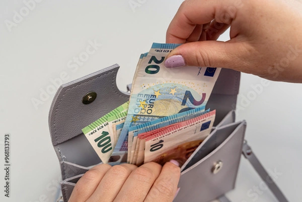 Obraz close up  woman taking euro money out of the wallet for shopping. Saving conept