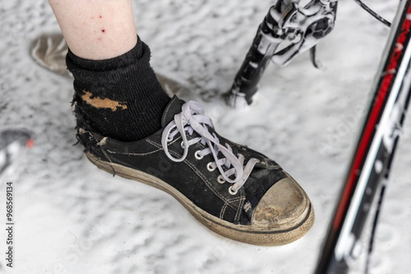Obraz A person's foot is shown with a sock and a shoe
