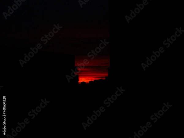 Obraz red sky sunset over the dark city