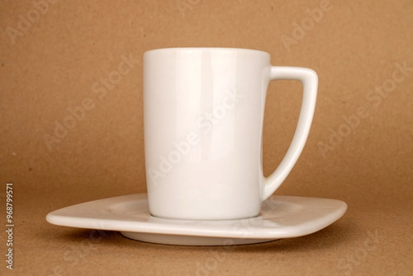 Fototapeta One ceramic cup and saucer on kraft paper, macro.