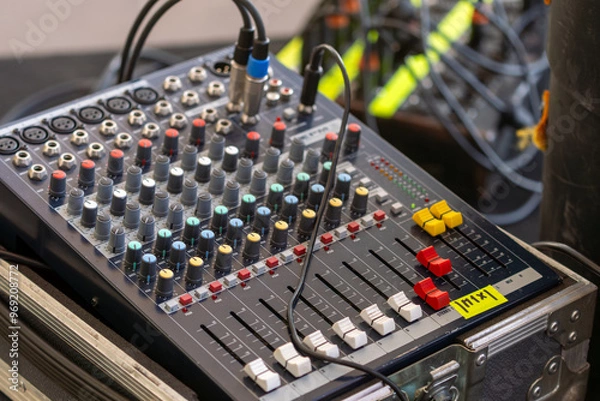 Fototapeta Sound control equipment positioned on the concert stage, used for managing audio levels and ensuring high-quality sound during live performances and events
