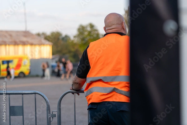 Fototapeta Security guard on the backstage of a concert, ensuring safety and smooth operations during the event