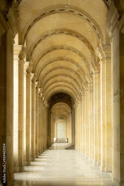Obraz Elegant corridor with arches and columns in a historic building.