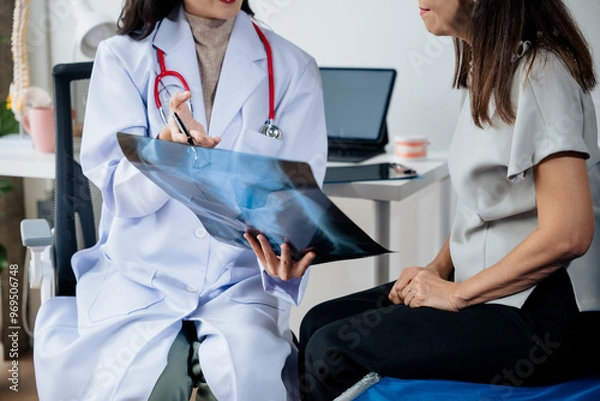 Fototapeta The doctor explain the old lady in retired life patient on lungs x-ray film and discuss treatment method to patient  in hospital nursing home aged care by using health and life insurance planning