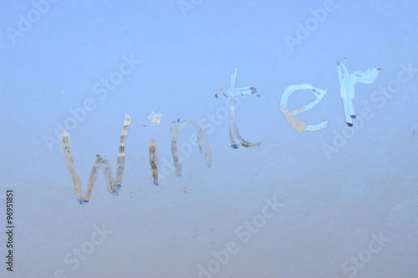 Fototapeta "winter" written on frosty winter window background.