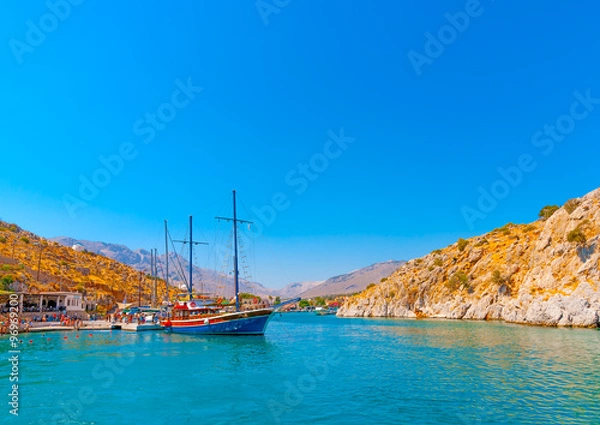 Fototapeta traditional wooden big sailing boat  docked at the port of Vathi village in Kalymnos island in Greece