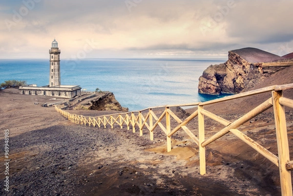 Fototapeta Lighthouse of Ponta dos Capelinhos scenic view with dramatic sky and warm colors, Azores