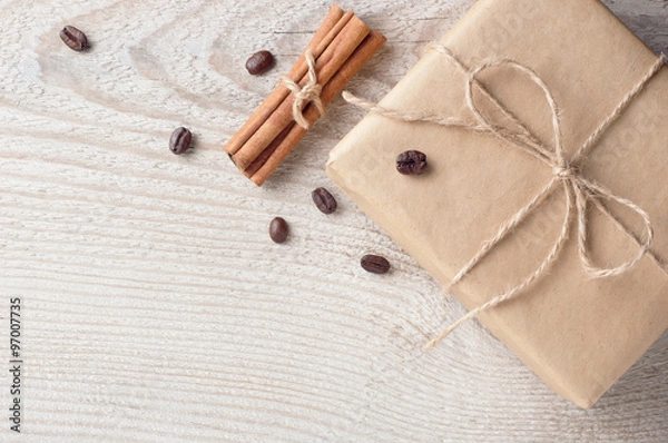 Obraz Gift box with blank tag nearby decorated coffee beans and cinnamon on white wooden table with space for text