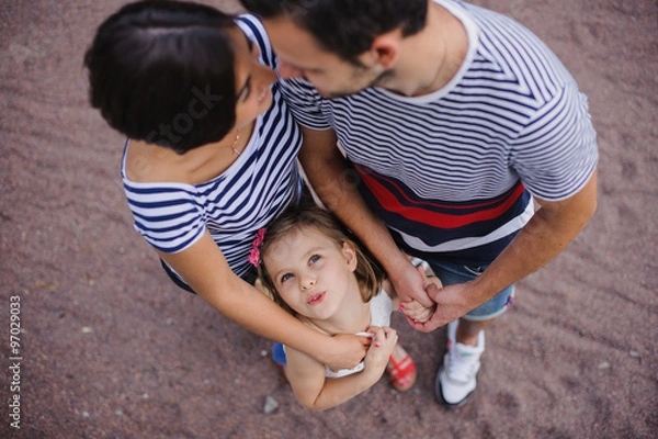 Obraz Parents with child stand having joined hands