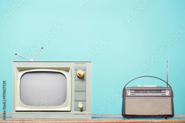 Obraz Old TV and vintage radio on table front mint blue background. Retro style filtered photo
