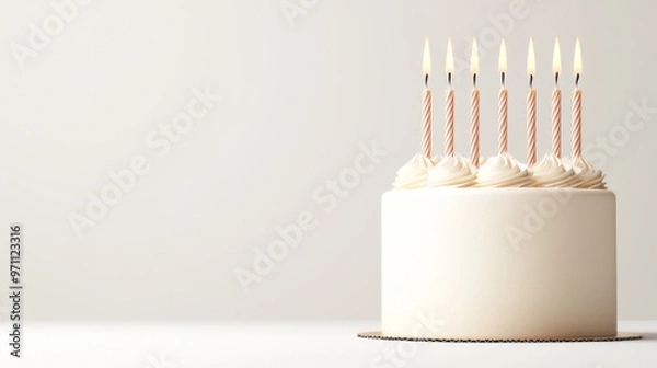 Obraz A simple and elegant birthday cake with lit candles, perfect for celebrations and festive occasions.
