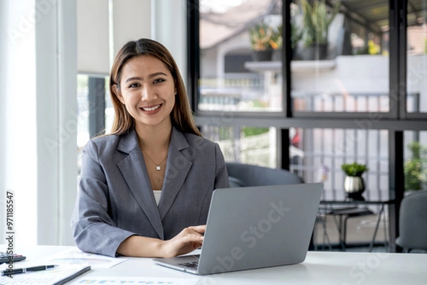 Fototapeta Businesswomen bookkeeper use laptop analysis the graph for Setting challenging business goals and ready to achieve target at home office