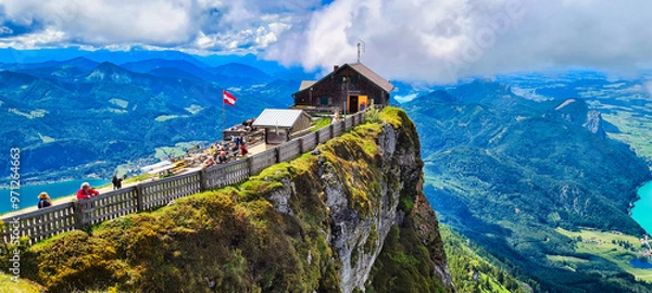 Fototapeta The Himmelspforte at Schafberg in Austria offers breathtaking panoramic views of the Austrian Alps and surrounding lakes. Perched on a cliffside, this iconic destination is a favorite for hikers and v