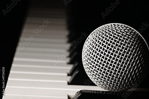 Fototapeta Microphone on a piano keyboard.
