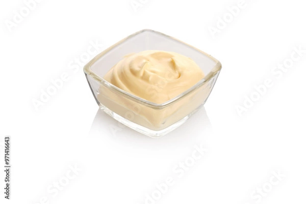 Obraz Creamy mayonnaise served in a clear glass bowl on a white surface in a simple and elegant presentation for culinary use