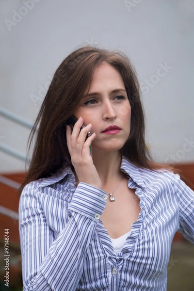 Obraz Pensive businesswoman on the phone.