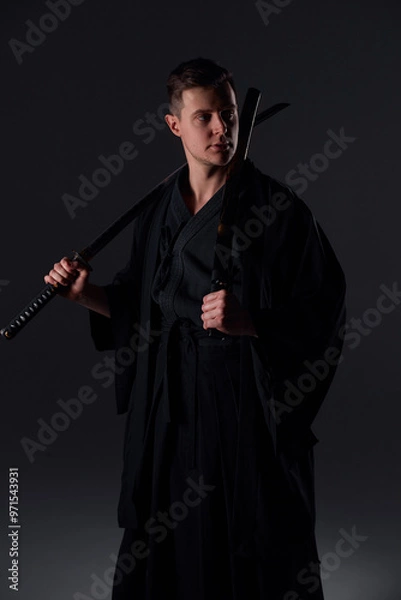 Fototapeta Samurai ninja warrior in kimono in attack pose with katana sword. dark room. sword shine. fighter. japanese culture
