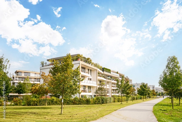 Obraz Residential area with ecological and sustainable green residential buildings, low-energy houses with apartments and green courtyard