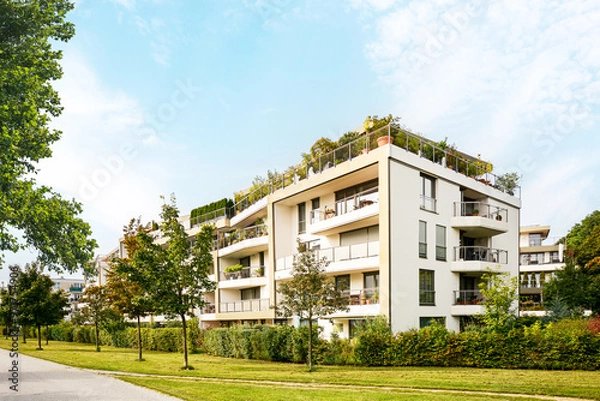 Obraz Residential area with ecological and sustainable green residential buildings, low-energy houses with apartments and green courtyard