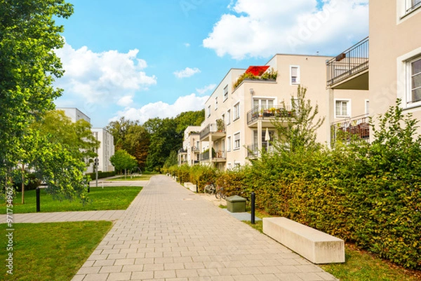 Obraz Residential area with ecological and sustainable green residential buildings, low-energy houses with apartments and green courtyard