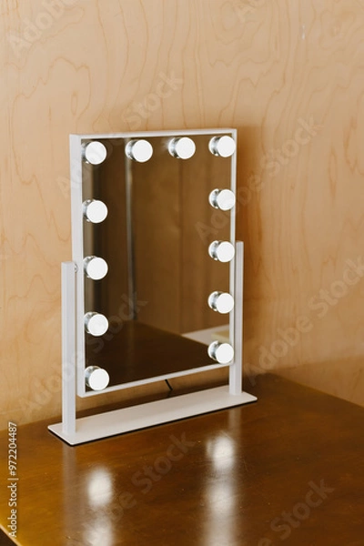Fototapeta A stylish vanity mirror with bright bulbs, perfect for makeup application and grooming. Its sleek design complements any decor, adding elegance to your space