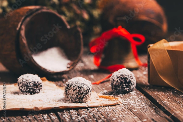 Obraz Coconut chocolate balls with Christmas decoration in a background