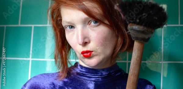 Fototapeta Portrait of a nice woman in a bathroom with broomerstick in hand, funny concept glamour housekeeping